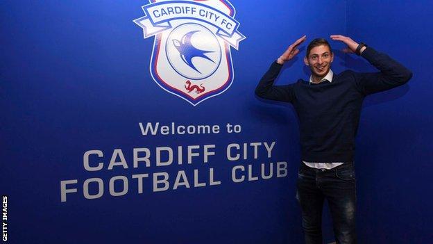 Emiliano Sala pictured in front of a Cardiff City crest after signing for the club