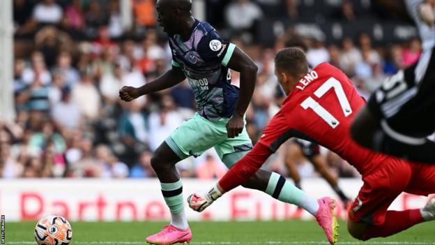 Brentford's Yoane Wissa rounds Fulham goalkeeper Bernd Leno