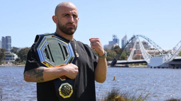 Alexander Volkanovski poses with his featherweight title in Perth, Australia