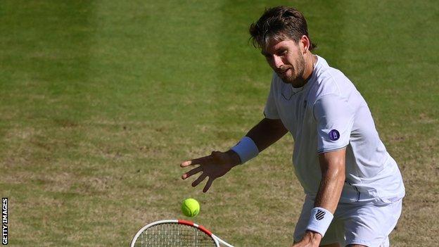 Cameron Norrie hits a return against Novak Djokovic in the Wimbledon semi-finals