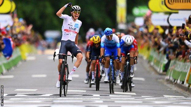 Tadej Pogacar celebrates winning stage six