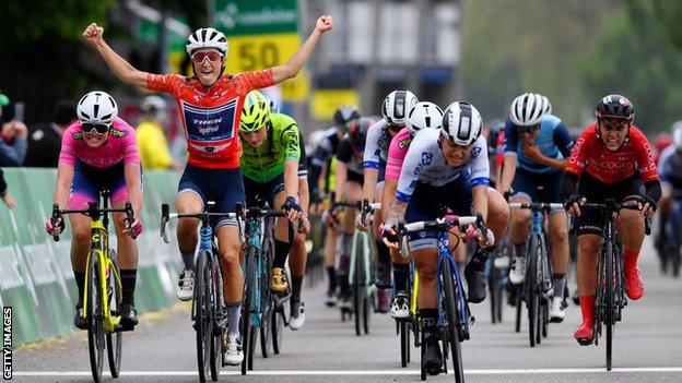 Lizzie Deignan celebrates winning the Tour de Suisse as she crosses the line