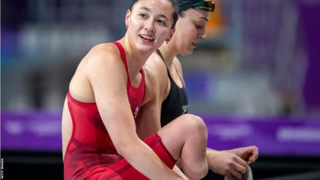 Alice Tai sits down after competing in the women's 100m freestyle S9 final during the Birmingham 2022 Commonwealth Games