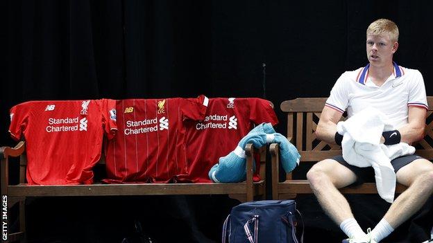 Football fan Kyle Edmund laid out three Liverpool shirts on his bench in celebration of his team's Premier League title win