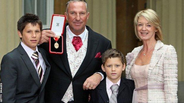 Sir Ian Botham at his investiture in Buckingham Palace in 2007 with his wife Kathy and grandsons Regan (left) and James.