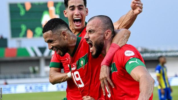 Morocco players celebrate a goal by Romain Saiss against Tanzania