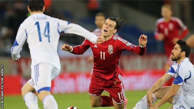 Gareth Bale is brought down by Cyprus midfielder Marios Nikolaou