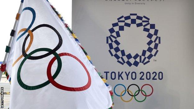 An Olympic flag and the logo of the Tokyo 2020 Games