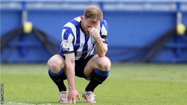 Tom Lees crouches in disappointment after being dispossessed in the lead-up to Jamal Lowe's goal