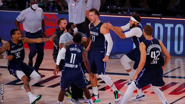 Luka Doncic celebrates his buzzer beater with team-mates