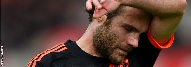 Juan Mata wipes his face after Manchester United's 2-0 defeat at Stoke