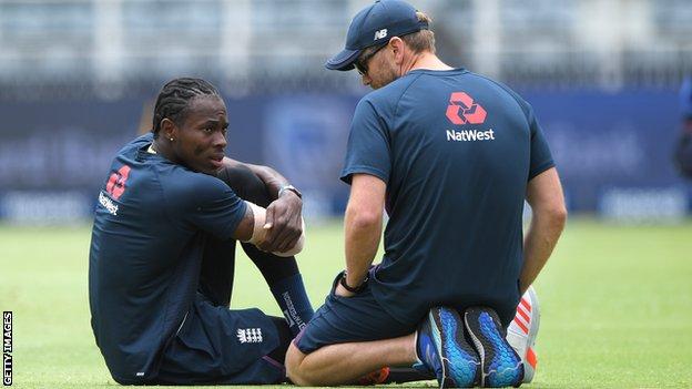 England fast bowler Jofra Archer talks to a physio about his elbow injury during a training session