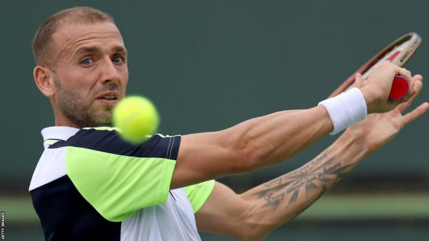 Dan Evans plays a backhand