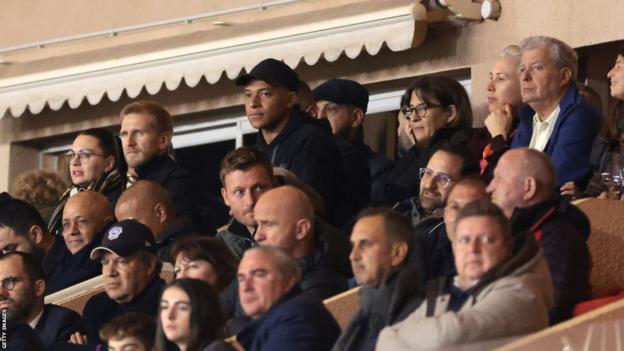 Kylian Mbappe watches PSG's game against Monaco from the stands with his mother