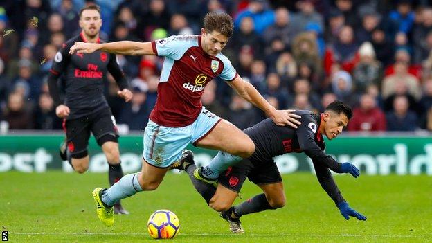 Burnley defender James Tarkowski challenges Arsenal's Alexis Sanchez