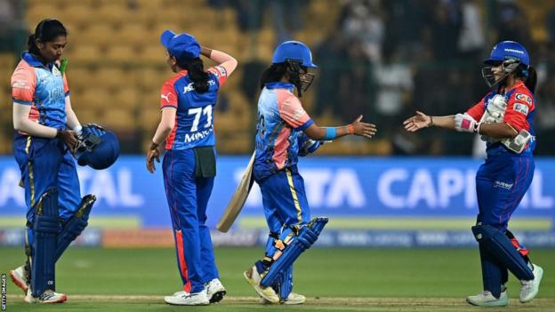 The Mumbai Indians celebrate beating Delhi Capitals in the opening game of the Women's Premier League