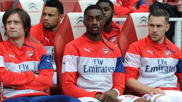 Semi Ajayi on the substitutes bench between Tomas Rosicky (left) and Aaron Ramsey