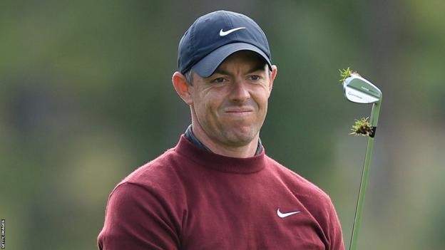 Rory McIlroy watches the golf ball after playing a shot