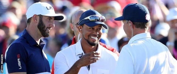 ustin Johnson, vice-captain Tiger Woods and captain Davis Love III of the United States celebrate after winning the Ryder Cup during singles matches of the 2016 Ryder Cup