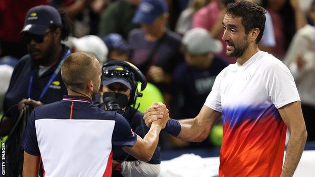 Dan Evans and Marin Cilic shake hands after their US Open match