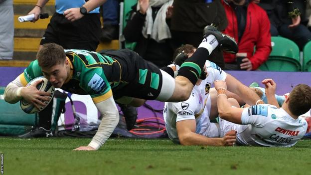 Tommy Freeman dives over for an early try for Northampton