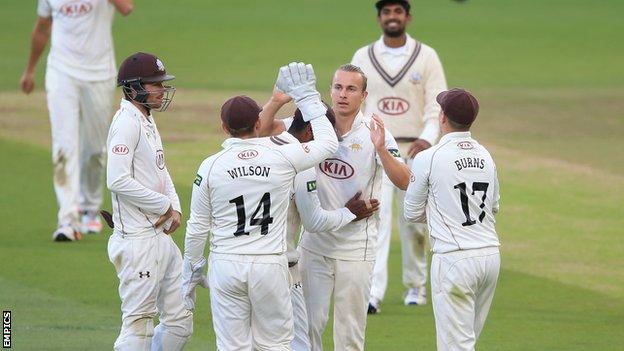 Surrey players celebrate a wicket