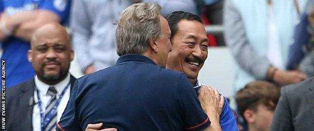 Cardiff City owner Vincent Tan (R)embraces Bluebirds manager Neil Warnock after a game