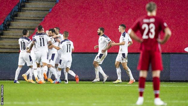 Serbia celebrate as Erling Haaland watches on