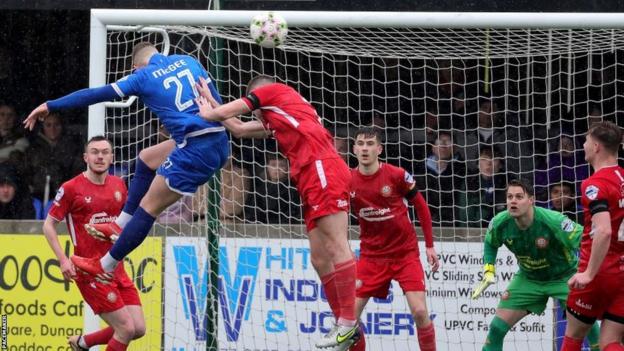 Ethan McGee rises to head home for Dungannon
