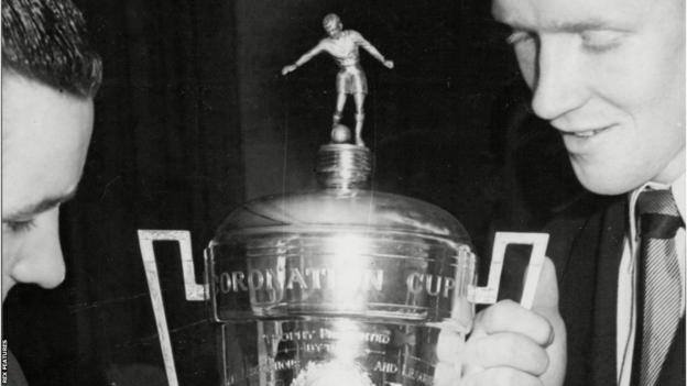 Coronation Cup being held by two Celtic players