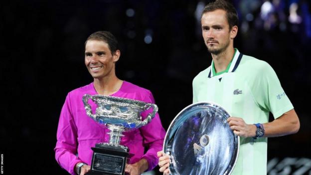 Spain's Rafael Nadal (L) poses with the winner's trophy next to Russia's Daniil Medvedev