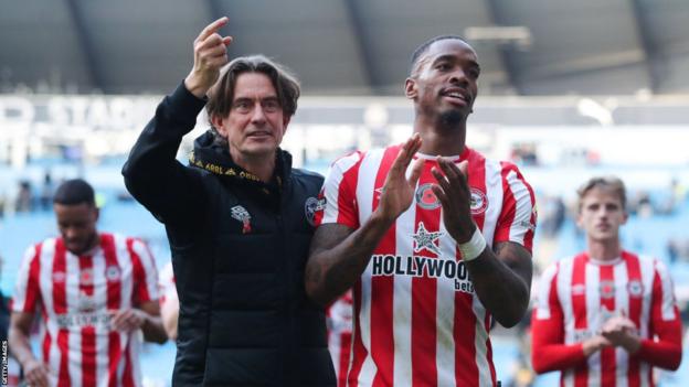 Thomas Frank, manager of Brentford, celebrates towards the away support with Ivan Toney