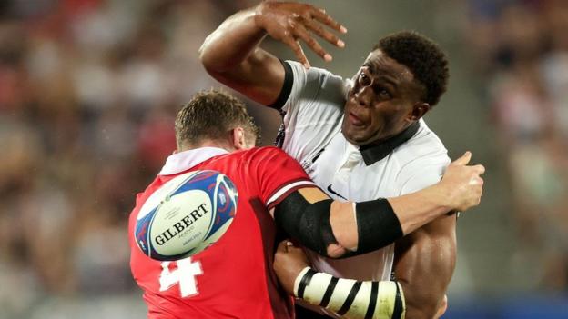 Wales Will Rowlands tackles Viliame Mata of Fiji