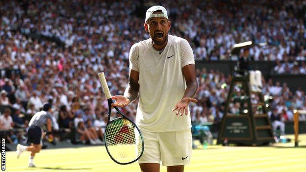 Nick Kyrgios holds his hands out in outrage on court
