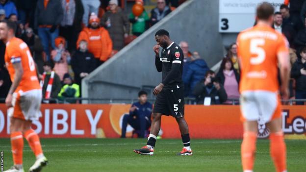 Ricardo Santos of Bolton Wanderers dejected following a red card against Blackpool