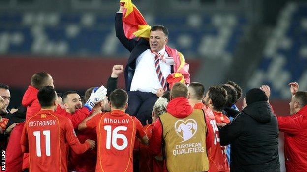 North Macedonia coach Igor Angelovski celebrates with his players after qualifying for Euro 2020