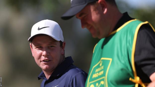 Bob MacIntyre chats with new caddie Michael Burrows at the season-ending DP World Tour event in Dubai