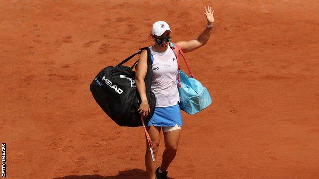 Ashleigh Barty waves as she leaves the court