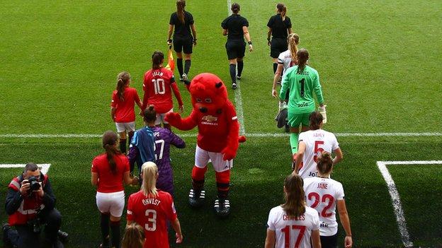 Manchester United Women and Liverpool Women walk out at Leigh Sports Village
