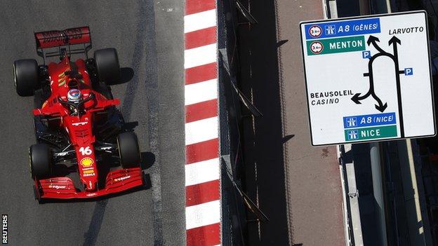 Charles Leclerc drives past a road sign