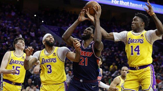 Joel Embiid (centre) in action against the Los Angeles Lakers