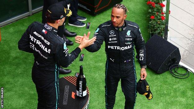 George Russell and Lewis Hamilton shake hands