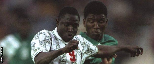 Rashidi Yekini of Nigeria holds off Zambian attempts during the 1994 Nations Cup final, which Nigeria won 2-1.