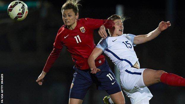 Nora Holstad of Norway competes for the ball with Ellen White of England
