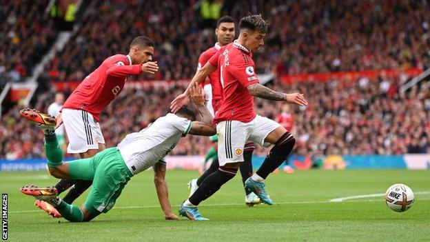 Newcastle's Callum Wilson goes down under a challenge from Manchester United's Raphael Varane