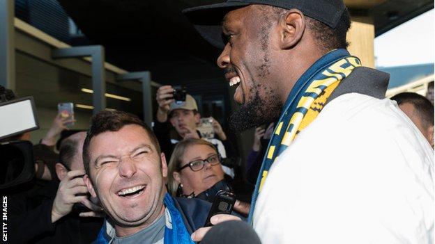 Bolt laughs with fans at Sydney airport