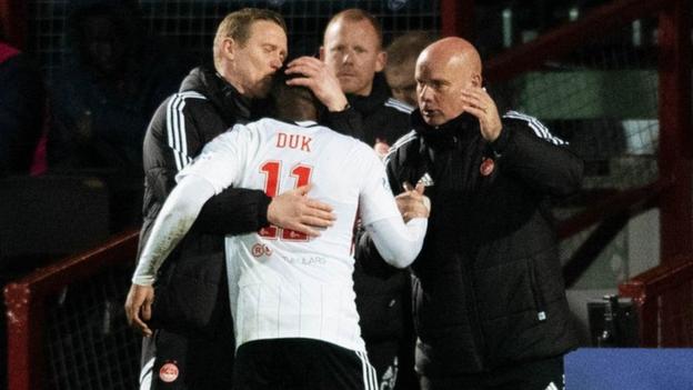 Duk celebrates with Aberdeen staff