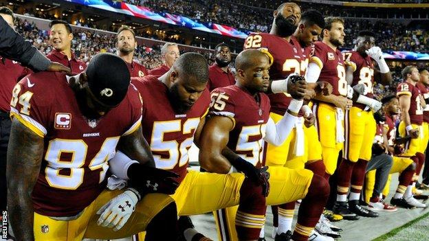 Washington Redskins players taking a knee as protest before an NFL game