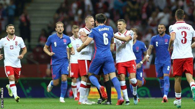 Harry Maguire of England and Kamil Glik of Poland clash during the 2022 Fifa World Cup Qualifier match between Poland and England