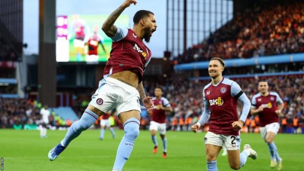 Douglas Luiz celebrates scoring his second goal against West Ham